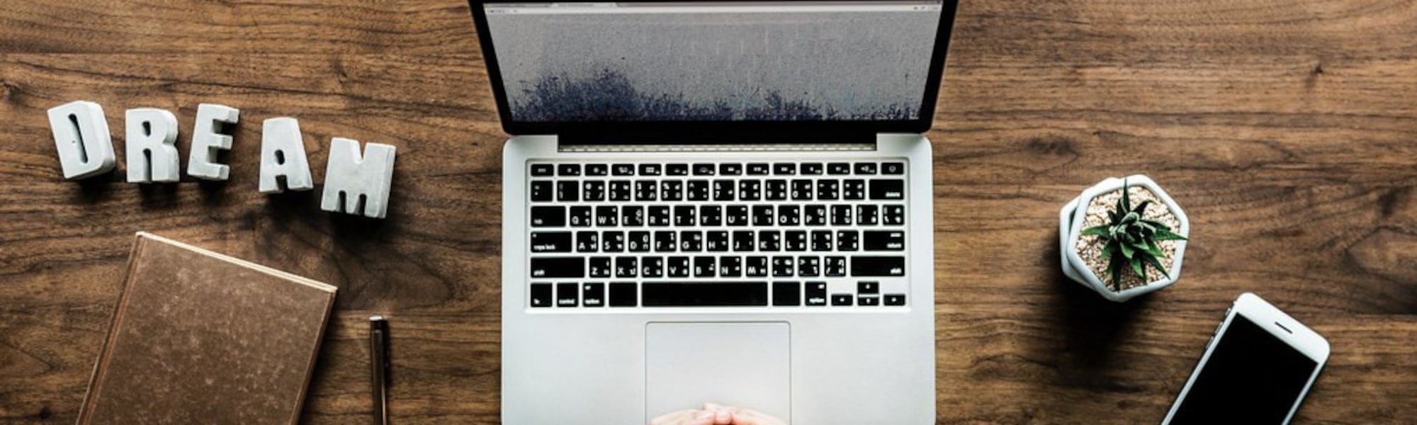 image of laptop on desk - promoting online courses